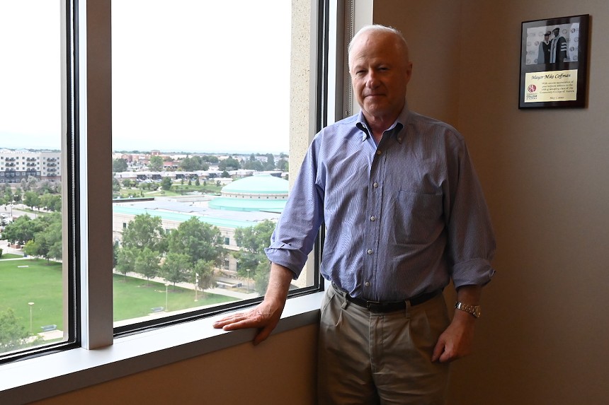 Aurora Mayor Mike Coffman stands in his office near a window overlook the city's center.
