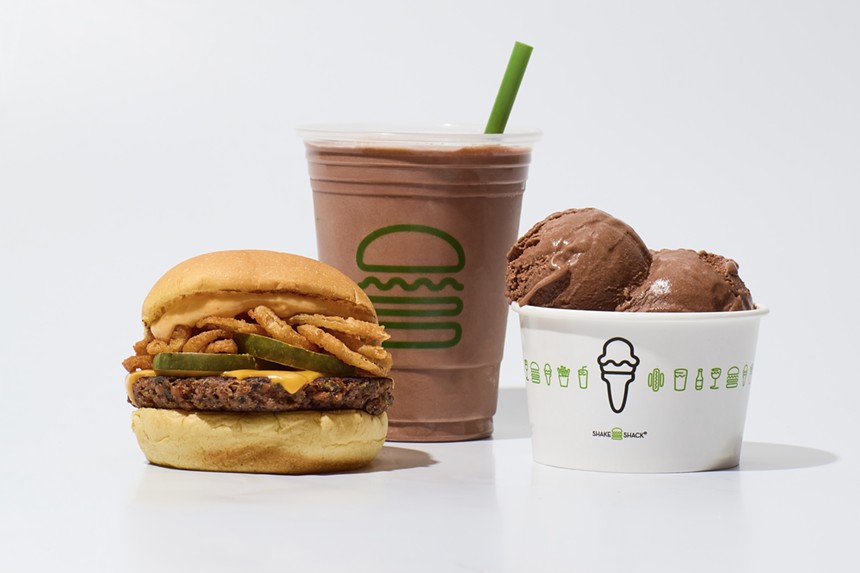 a burger next to a milkshake and scoops of ice cream in a cup