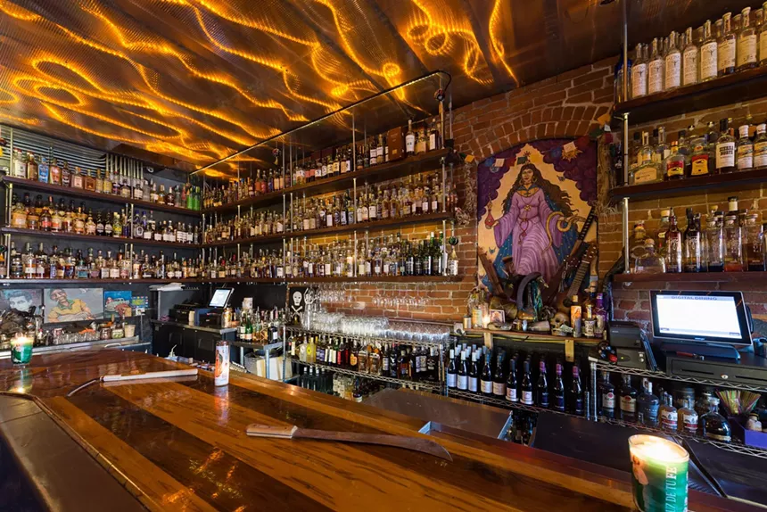 a bar back lined with bottles