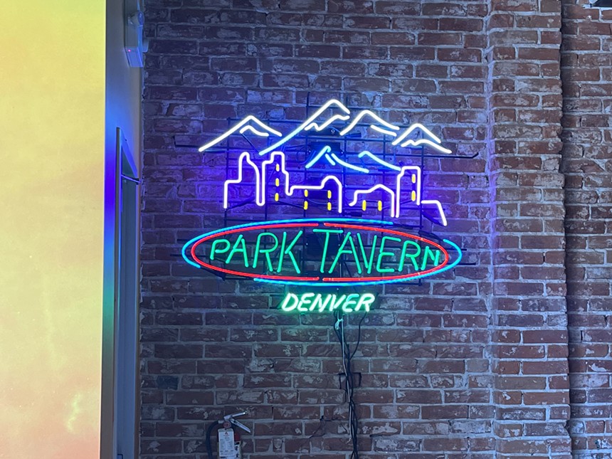 a neon sign on a brick wall