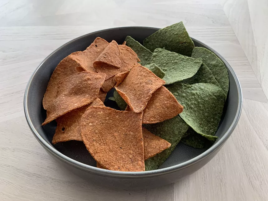 red and green tortilla chips in a bowl