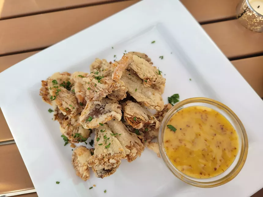 white plate with fried oysters and lemon
