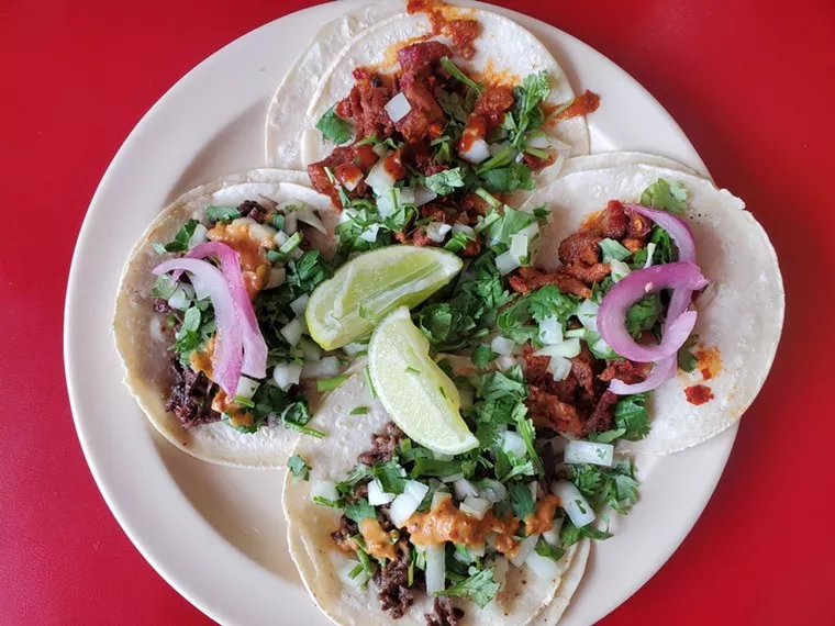 four tacos on a plate