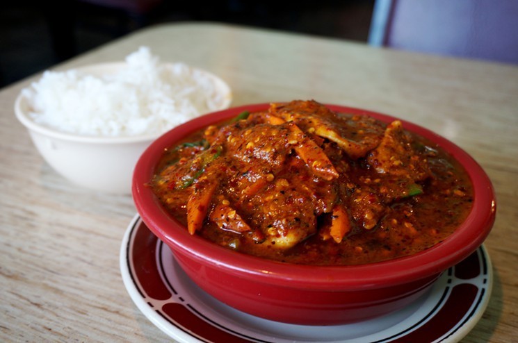 a bowl of meat in red sauce