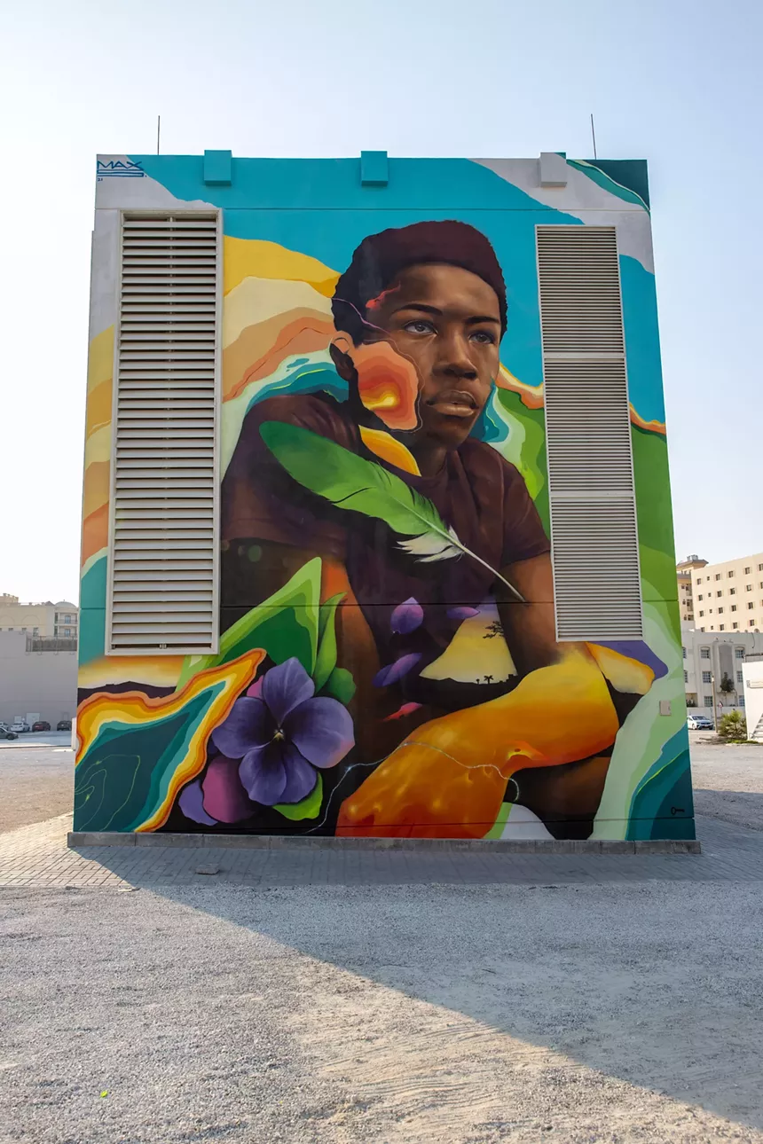 painting of a black boy on the side of a building