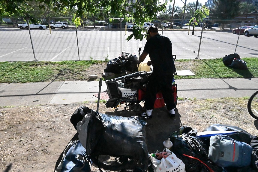 Alejandro Castañeda cleans up on Logan Street.