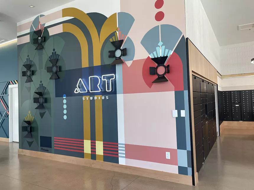 An abstract mural with greens, blues and pinks.