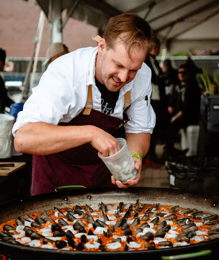 A man making paella at Denver Food + Wine