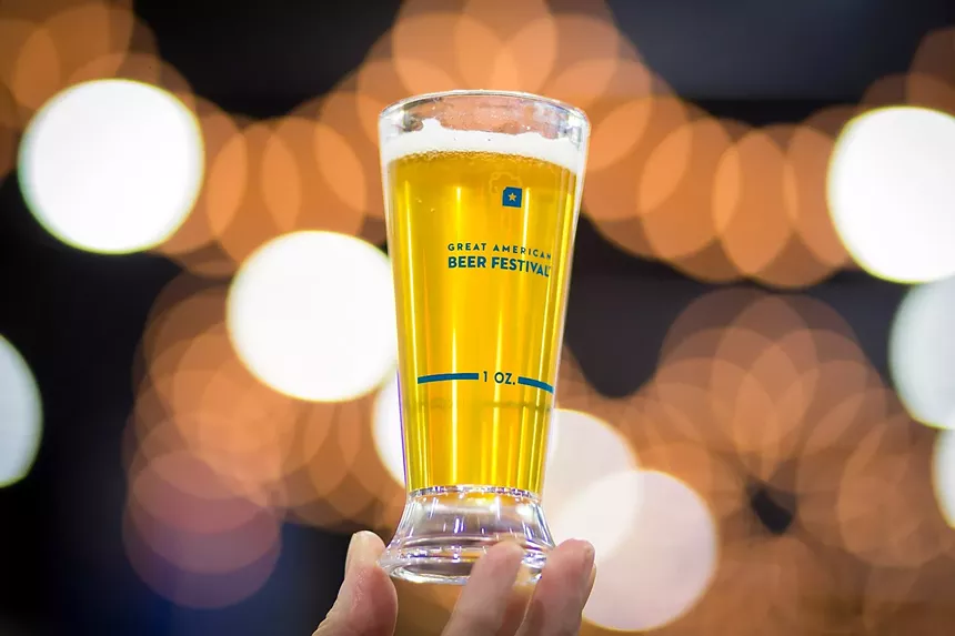 Small sampler glass will golden beer inside.