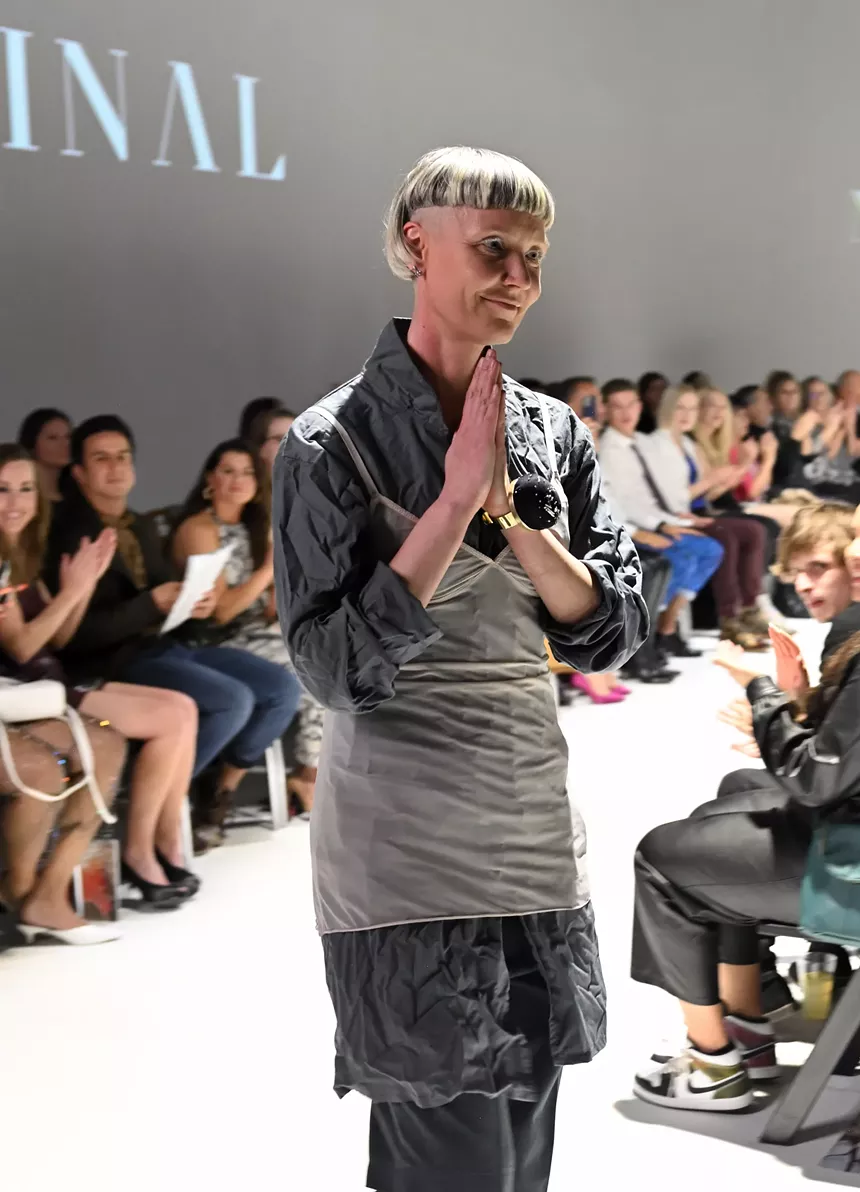 fashion designer with short blonde hair