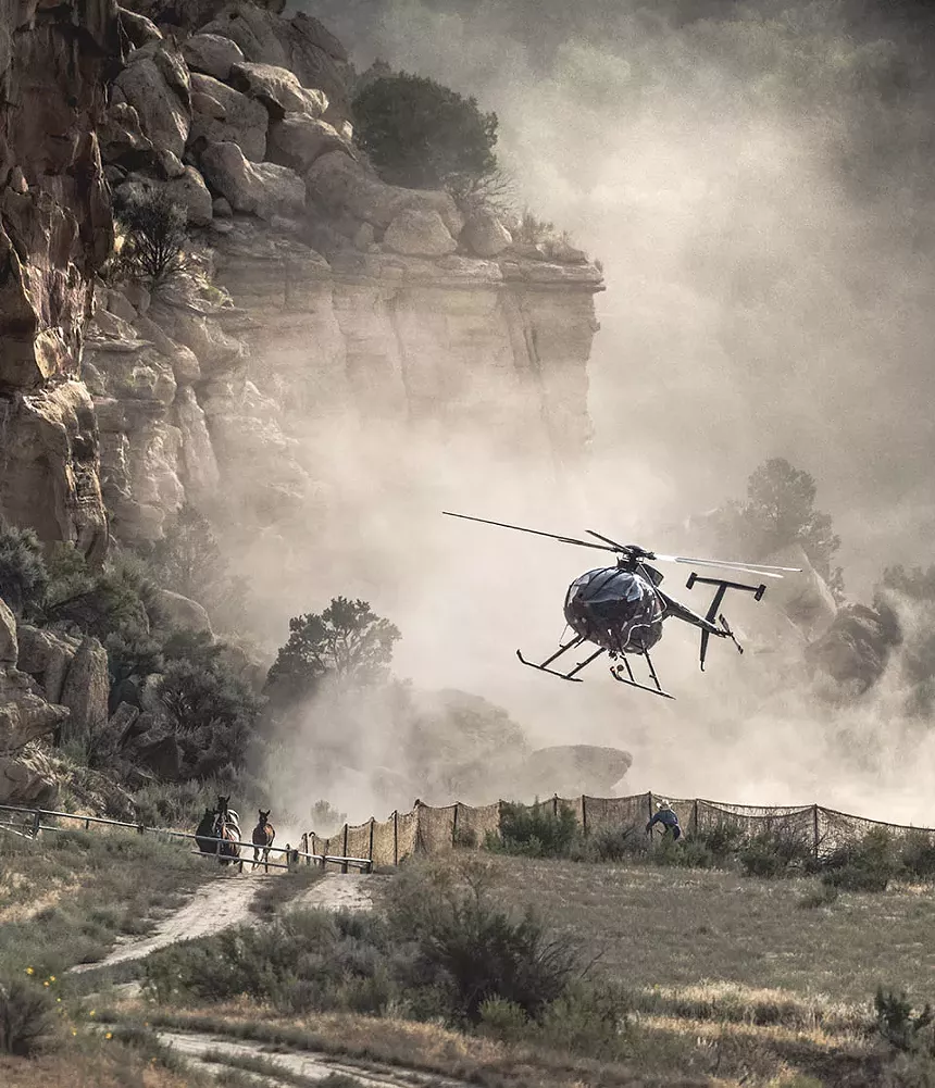 helicopter chasing horses