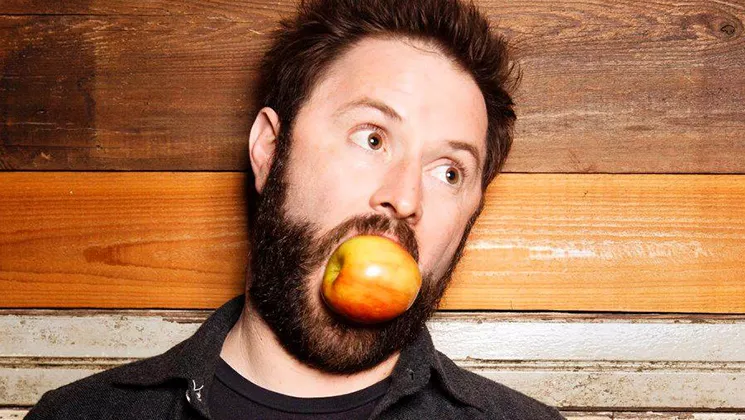 man with an apple in his mouth