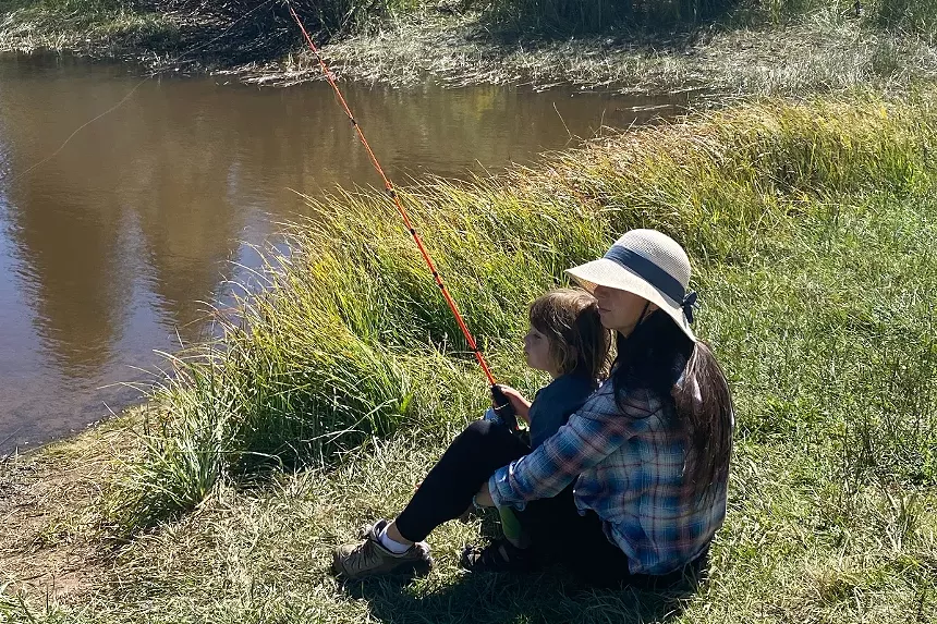 A mother and her son fish while attending a Cal-Wood Education Center Latino Family Camp in the summer of 2023.