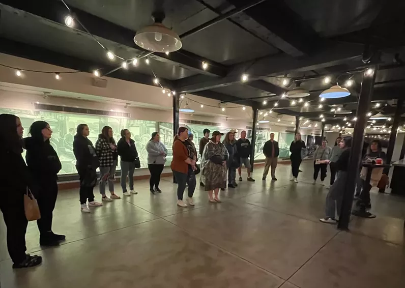 Guests walk in a Denver building during a ghost tour