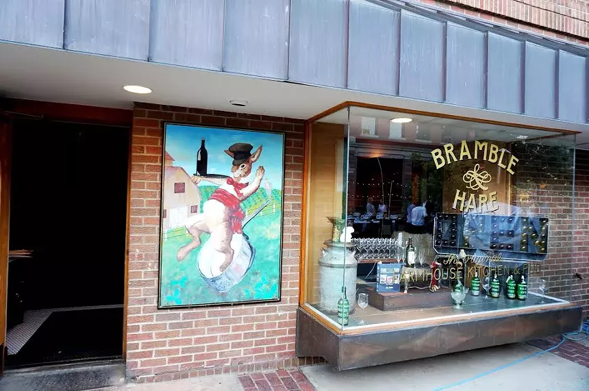 front of building with mural and glass window
