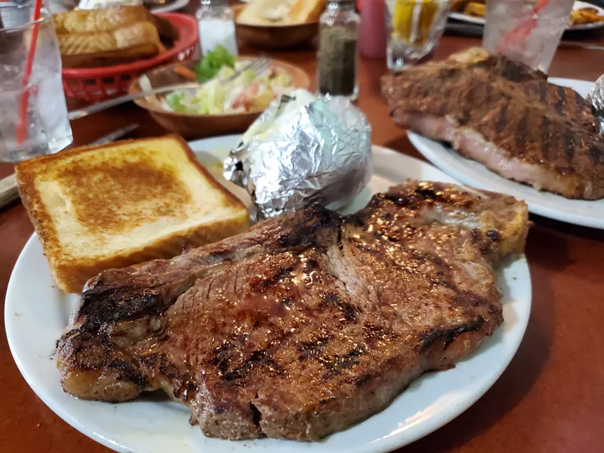 a steak with a potato wrapped in foil