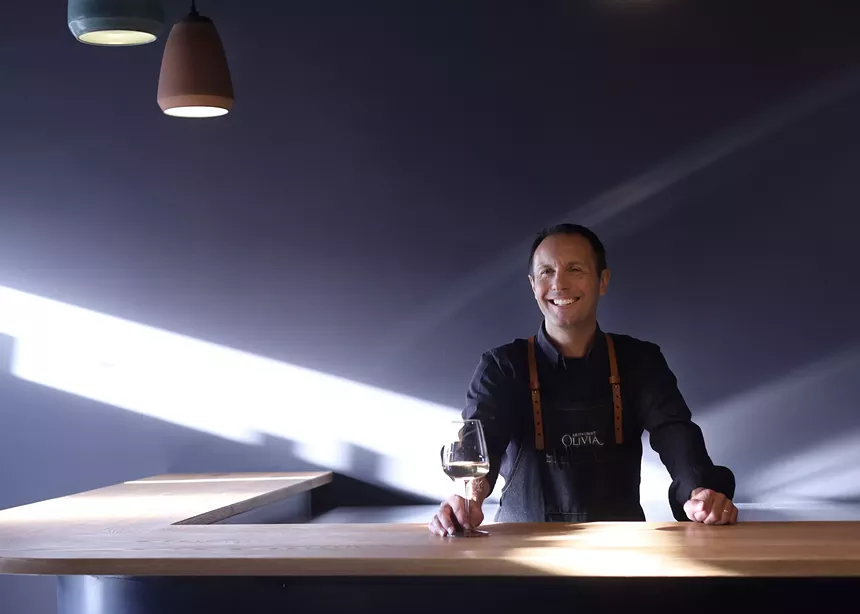a man standing behind a bar