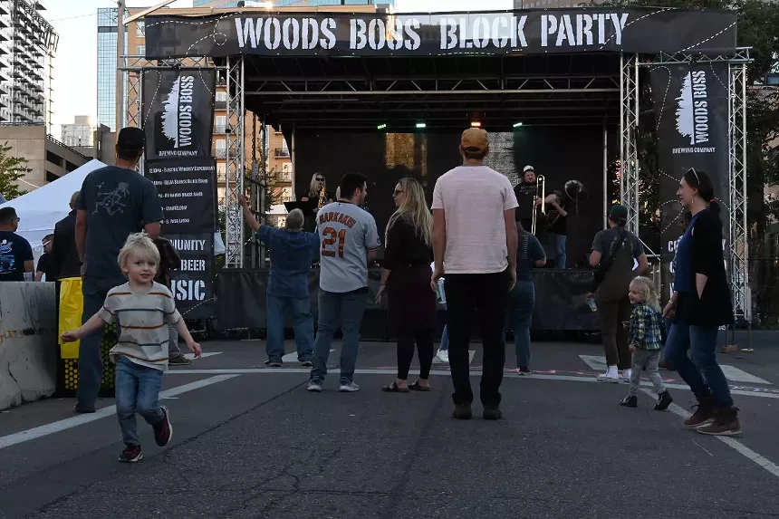 A child runs around during the Woods Boss 2023 block party.