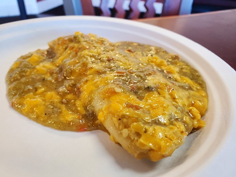 a tamale smothered in green chile and cheese