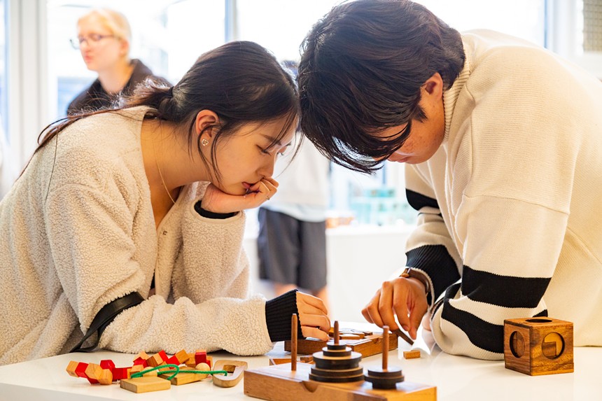 couple playing with wooden toys