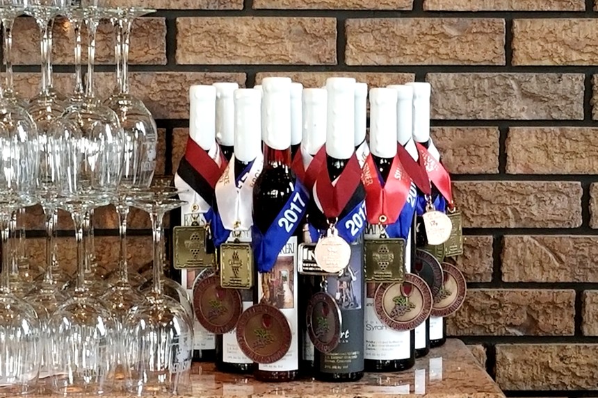 bottles of wine with medals hanging on them