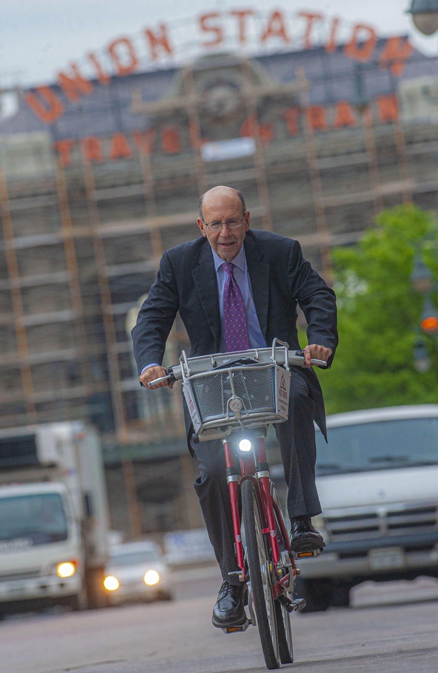 man on bike in suit in front of Union Station