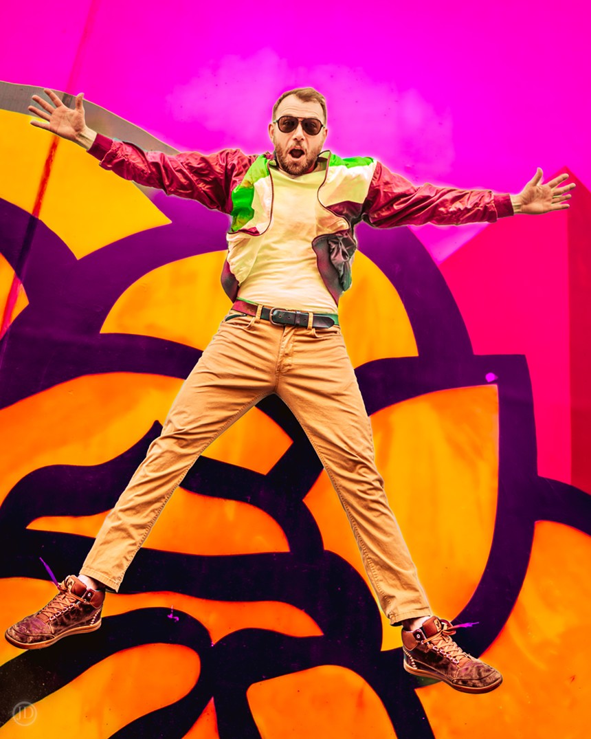 man jumping in the air against neon pink background