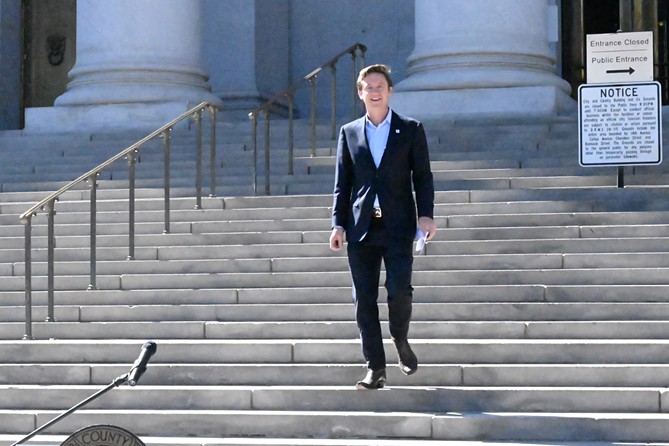 Mayor Mike Johnston walks down the steps during a September 28 press conference.