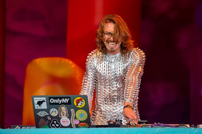 man in silver suit deejaying