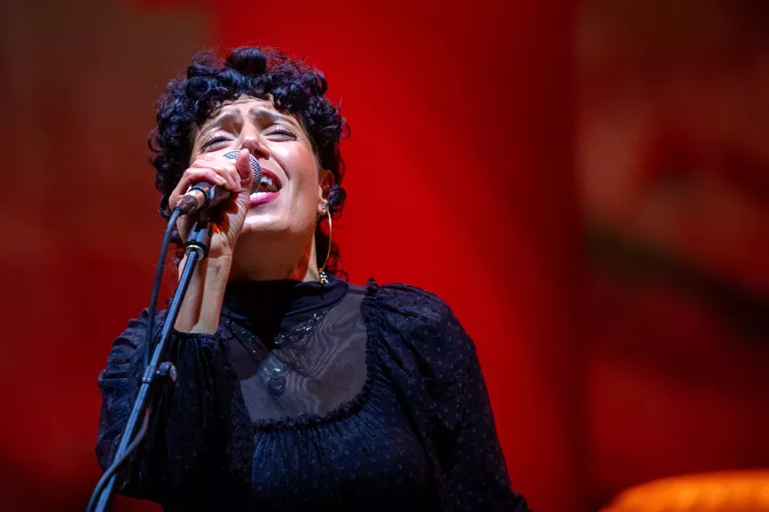 woman sings into microphone
