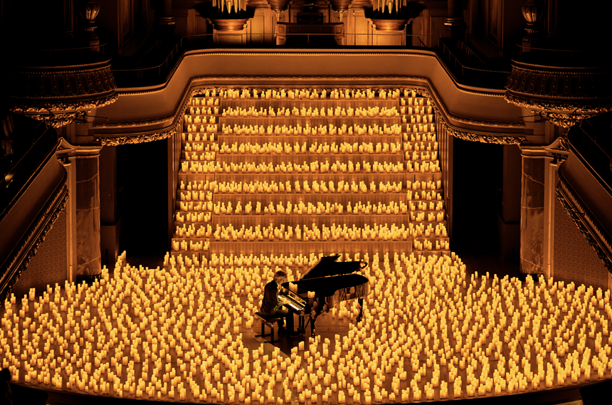 musicians playing instruments surrounded by candles