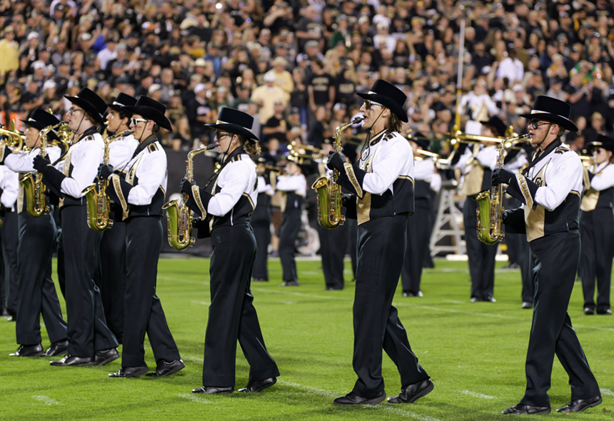 People play instruments wearing black and white.