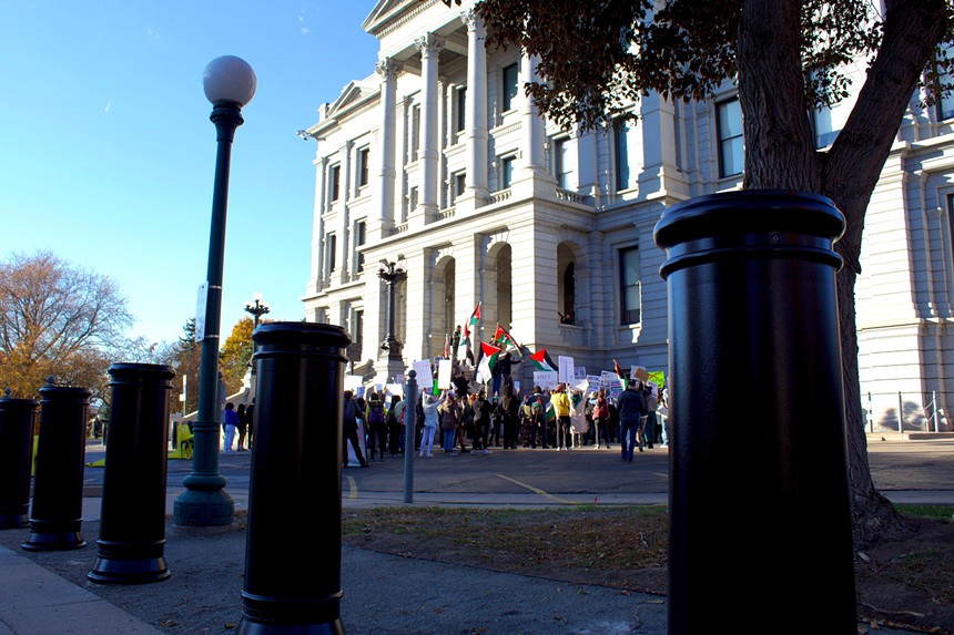 A group of pro-Palestine protestors rally outside of the south entrance to the Colorado Capitol Building.
