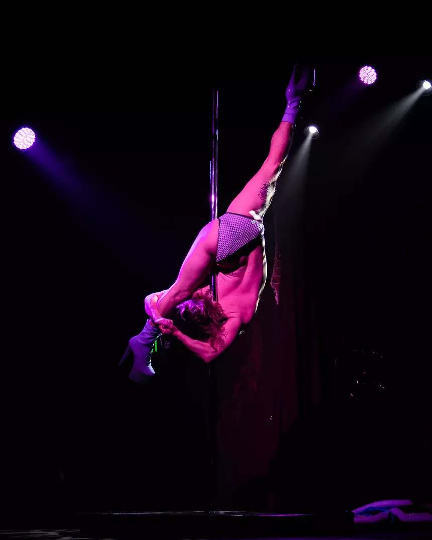 person stretching on a pole