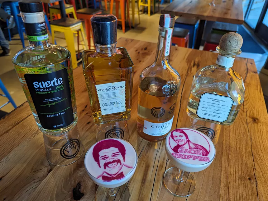 four bottles of tequila behind two cocktails
