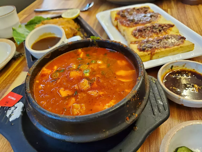 red soup in a black bowl