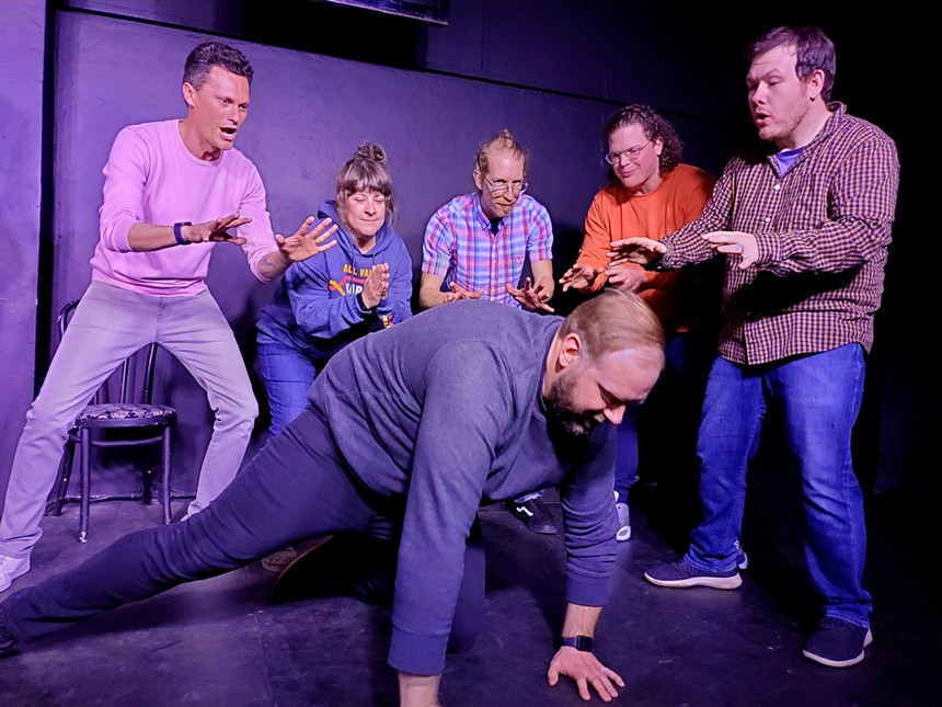 improv actors with man on floor.