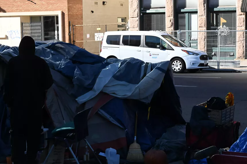 A HOST van is park outside an encampment on Curtis Street.