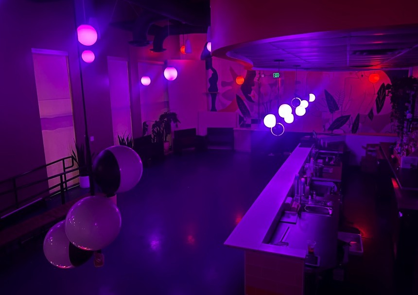 a purple-lit empty dance floor