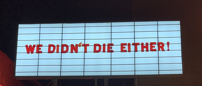 The Esquire Theater's marquee sign displays the message: "We didn't die either!"