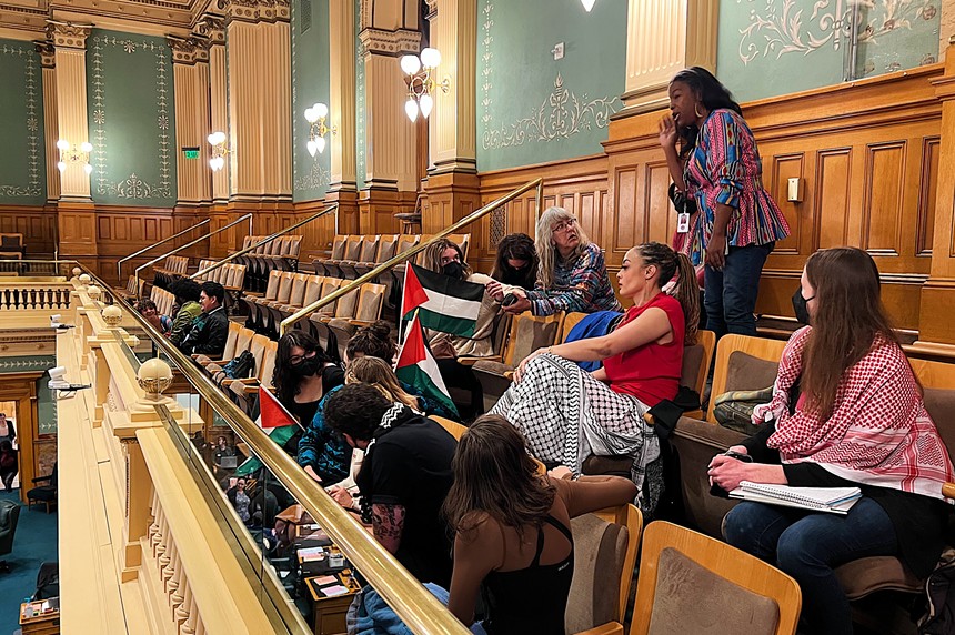 Representative Elisabeth Epps sits with a group of pro-Palestine protestors in the House gallery.