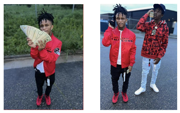 Men in red jackets pose with money