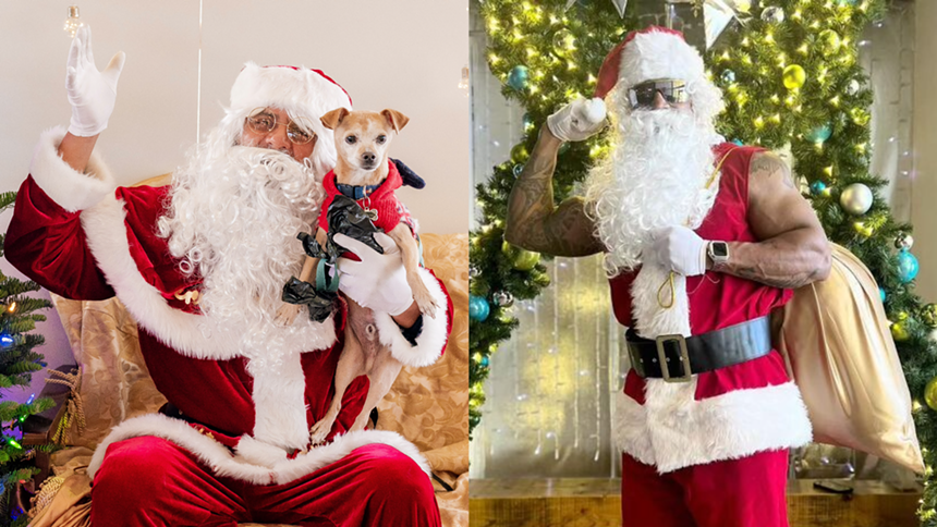 Two men dressed as Santa Claus, one who is Hispanic and one who is Black.