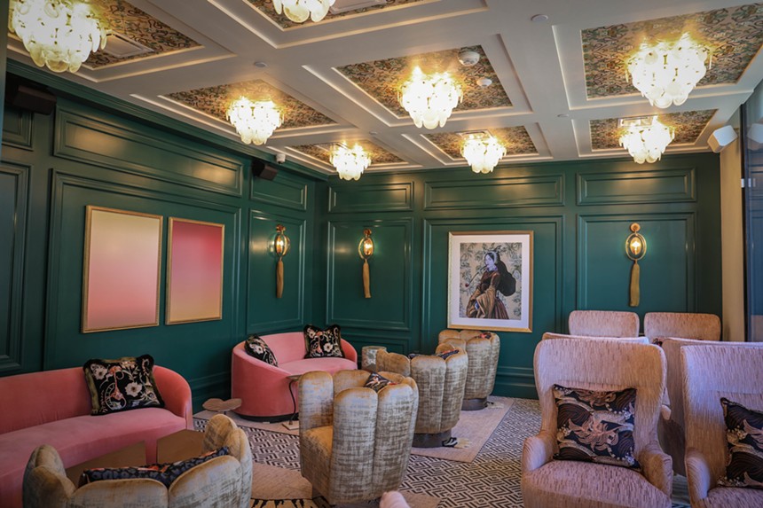 a room with pink couches and green walls