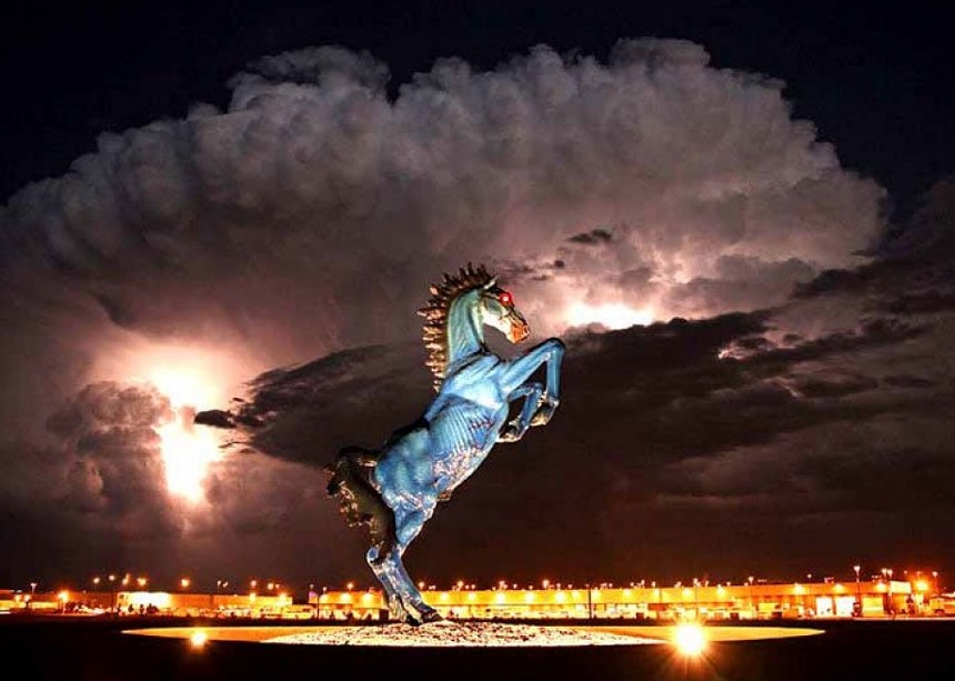 blue horse sculpture against storm