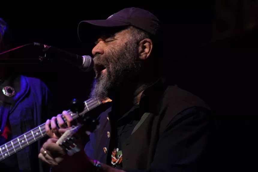 man singing and playing guitar