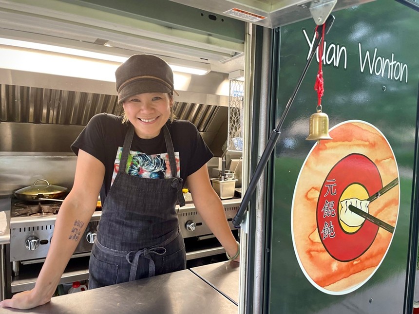 a woman standing in a food truck