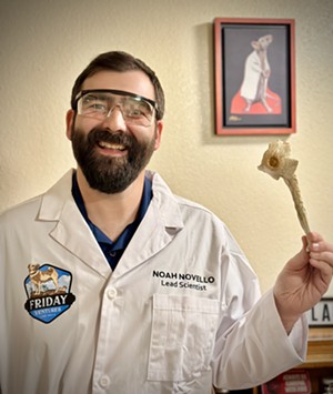 Man in a lab coat holds a magic mushroom