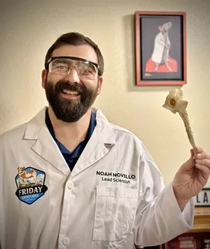 Man in a lab coat holds a magic mushroom