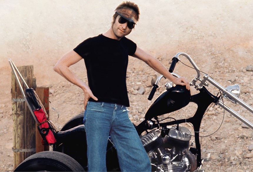 john lennon in headband with motorcycle